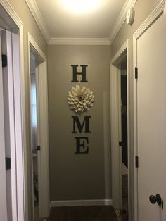 the hallway is decorated in gray and white with a large flower on it's wall