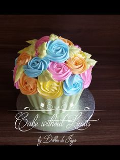 a cupcake with colorful frosting and flowers on top