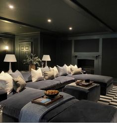 a living room filled with lots of couches and pillows on top of it's covers