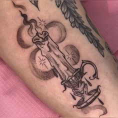 a woman's leg with tattoos on it and an arrow in the middle of her leg