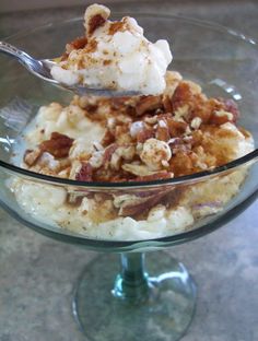 a glass bowl filled with ice cream and nuts