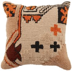 a decorative pillow with an orange and black design on the front, along with two crosses