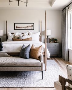 a bedroom with a canopy bed and pillows