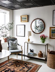 a living room filled with furniture and pictures on the wall