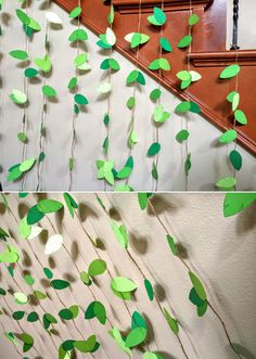 some green paper leaves hanging from the side of a stair case next to a wall