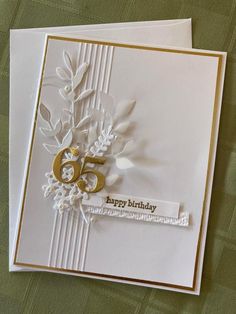 a white card with gold numbers and flowers