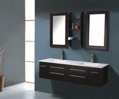 a bathroom vanity with two mirrors above it and a vase on the floor next to it