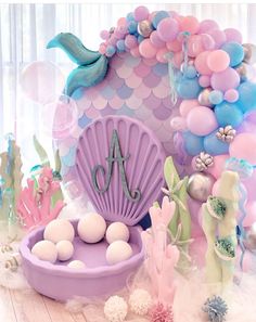 there is a mermaid themed birthday party with balloons and decorations