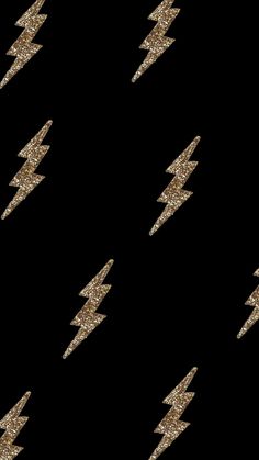 gold glitter lightning bolt pattern on black background