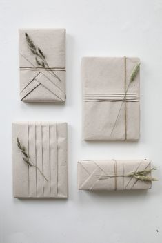 four pieces of paper wrapped in twine and tied together with grass sprigs