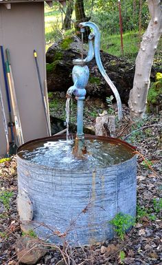 an old water well with a blue faucet