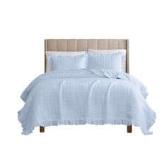 a bed with white comforter and pillows on top of the headboard, in front of a white background