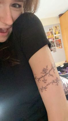 a woman with a flower tattoo on her arm