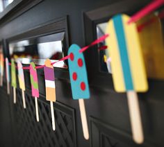 colorful popsicles are hanging on the wall