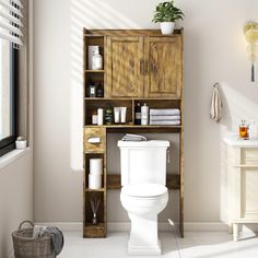 a white toilet sitting next to a wooden shelf filled with bathroom items on top of it