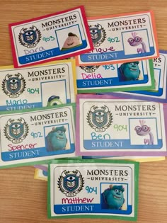 five monsters student id badges on a table