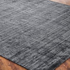 an area rug on the floor with wood floors and hardwooding in the background, it is