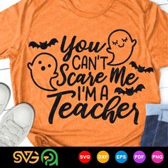 an orange t - shirt that says you can't scare me i'm a teacher