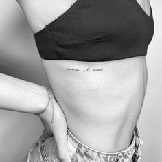 a woman's stomach with the word love tattooed on her lower back and side