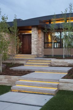 a modern home with steps leading to the front door