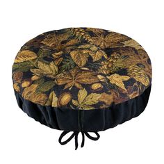 a black and gold flowered round cushion on a white background with an attached cord