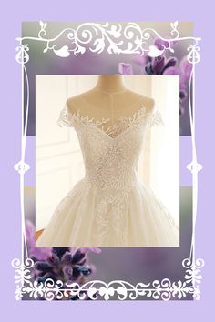 a wedding dress on display in front of a purple and white background with an ornate frame