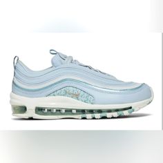 The Nike Women’s Air Max 97 ‘Blue Camo’ Showcases Cooling Tones On The Historic Running Shoe That Introduced Visible Full-Length Air. Subtle Shades Of Blue Permeate The Upper, Featuring A Mesh Base With Wavy Reflective Overlays That Provide Added Visibility In Low-Light Conditions. A Reflective Finish Is Similarly Applied To The Camo-Print Quarter Panel, Accented With A Mini-Swoosh In Silver Embroidery. The Sneaker Sits Atop A Solid White Polyurethane Midsole With A Max Air Unit That Runs The Le Blue Sneakers With Air Max Cushioning For Spring, Blue Air Max Sneakers For Spring, Blue Sneakers With Air Cushioning For Spring, Nike Air Max 97 Blue, Retro Sneakers Women, Silver Embroidery, Nike Waffle, Nike Tennis Shoes, Study Help