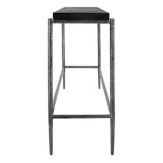 the backless stool is made from metal and has a black leather cushion on it