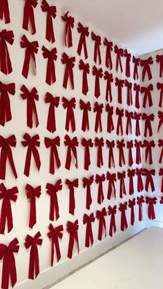 the wall is decorated with red bows and ribbons