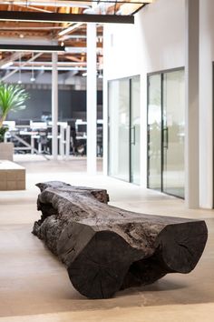 a large piece of wood sitting on top of a wooden floor in an office building