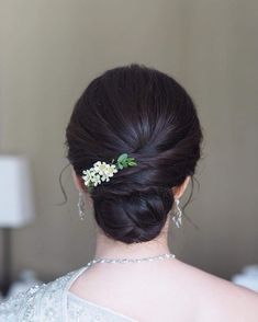 a woman in a white dress with a flower in her hair