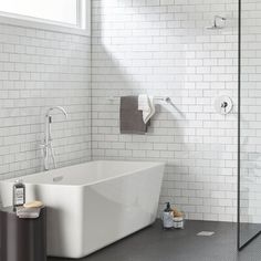 a white bath tub sitting next to a walk in shower