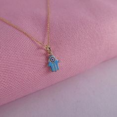 "\"Dainty Gold Hamsa Necklace | 14k Gold Hand of Fatima Pendant | Turquoise & Dark Blue Evil Eye Protection Talisman Charm | Gift for Her\" The hamsa is an ancient Middle Eastern symbol that holds a variety of meanings across cultures. Nevertheless, it is regarded in all faiths as a protective talisman that brings good fortune, health and happiness. You will never want to take off this minimalist necklace. Enamel art made with pure gold and handcrafted work will always preserve its color and 14k Gold Turquoise Pendant Jewelry, Dainty Turquoise Charm Necklace For Gift, Turquoise Hallmarked Jewelry For Gift, Turquoise Hallmarked Jewelry Gift, Blue Pendant Necklace In 14k Gold, Blue 14k Gold Pendant Necklace, Blue 14k Gold Round Pendant Necklace, Blue 14k Gold Round Pendant Jewelry, Turquoise Pendant Charm Necklace As Gift