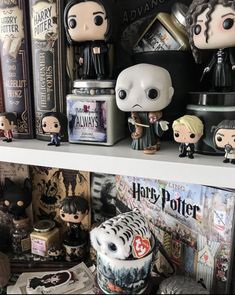 some harry potter figurines are on a shelf