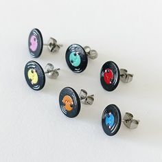 six pairs of cufflinks with cartoon characters on them