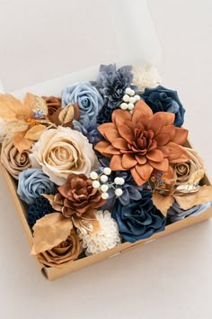 a box filled with flowers on top of a table