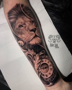 a man's arm with a lion and clock tattoo on the left side of his leg