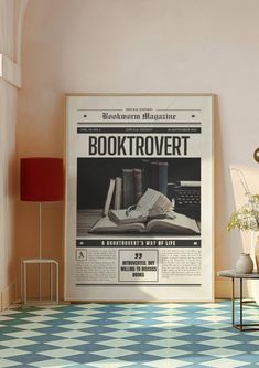 an old booktrover advertisement hangs on the wall next to a table with a lamp