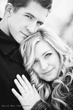 a man and woman are posing for a black and white photo with their arms around each other