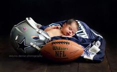 a baby sleeping on top of a football