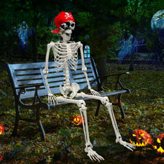 a skeleton sitting on a park bench with pumpkins