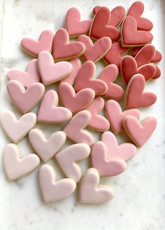 pink and red heart shaped cookies on a white counter