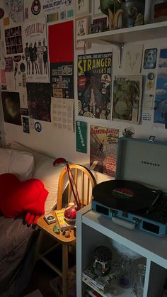 a bed room with a record player and a desk