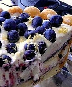 a close up of a cake with blueberries on it