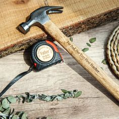 a hammer, rope and other tools on a wooden surface with leaves around it for decoration