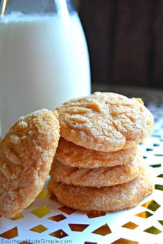 a stack of cookies next to a glass of milk