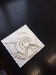 a piece of paper that looks like a clock on a table with scissors and other items around it