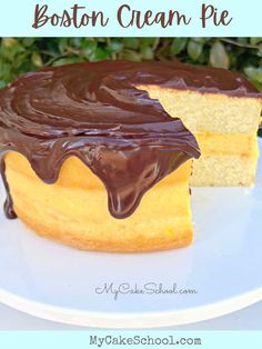 a close up of a cake on a plate with chocolate icing and the words boston cream pie