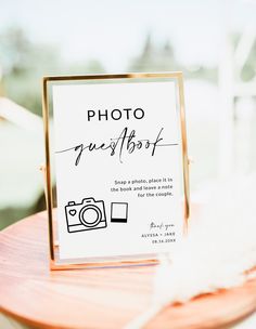 a sign that is sitting on top of a table with a camera in front of it