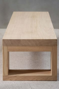 a wooden coffee table sitting on top of a white floor